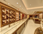 "Luxury jewelry showroom at Virani Jewelers featuring elegant 22K gold necklaces, bangles, and bridal jewelry displayed in glass cases and wall showcases with premium store interior design."