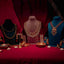 22K gold Indian jewelry by Virani set on mannequins and table with candles against a red curtain background