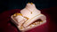 Set of 22k gold jewelry by Virani Jewelers on a pink stand against a dark background