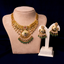 A traditional Indian necklace and earring set by Virani Jewelers with 22k yellow gold, emerald, ruby, CZ, and beaded accents