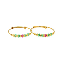 An image of two 22K gold bangles with an adjustable band and emerald and ruby bead embellishments from Virani Jewelers.