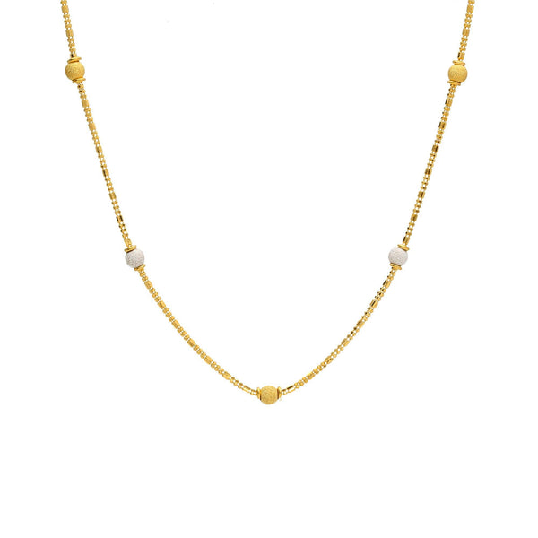 An image of a 22K gold necklace from Virani Jewelers with yellow and white gold beads spread throughout the wheat link chain. | Complement every outfit in your wardrobe with this gorgeous 22K gold chain from Virani Jewelers!
...