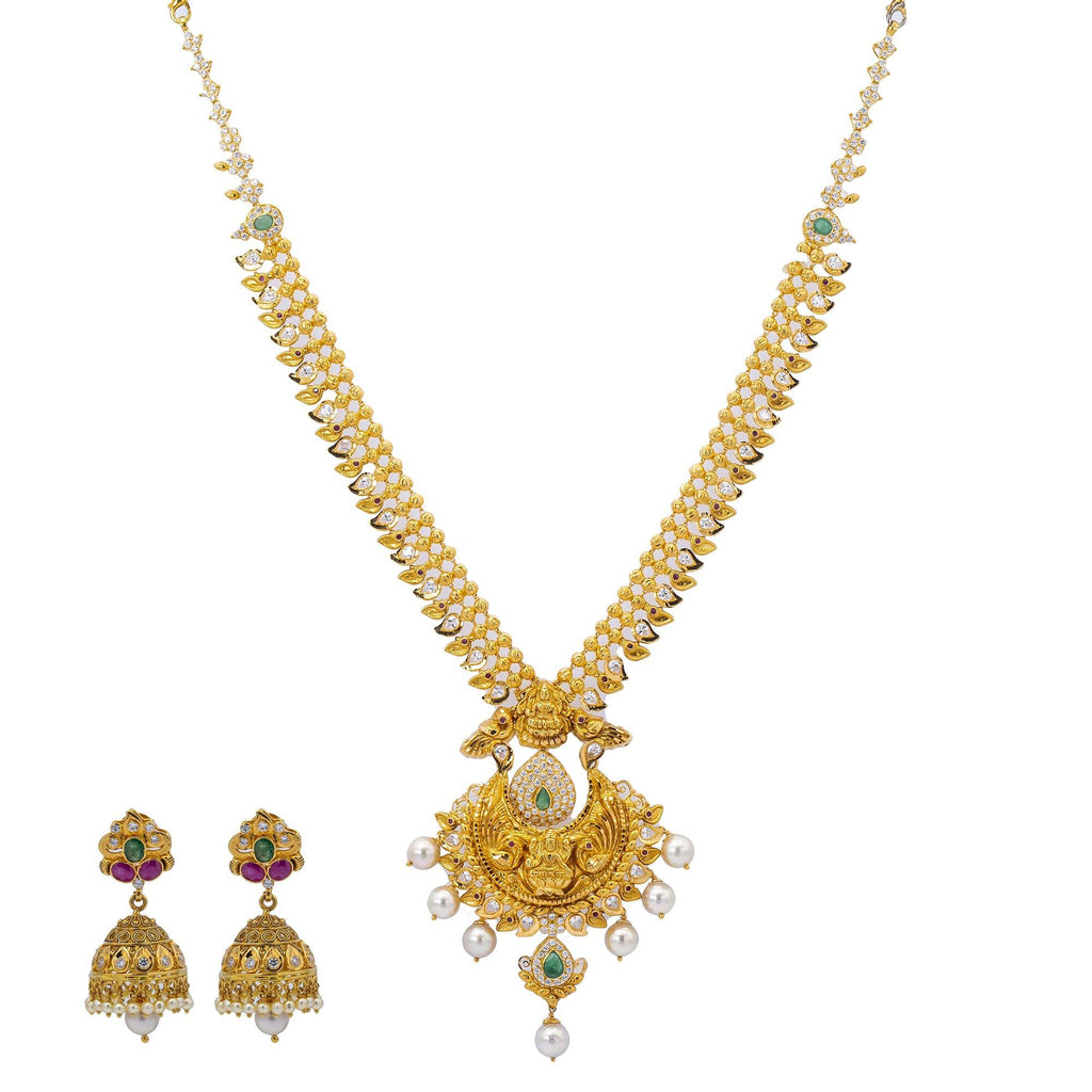 An image of the Ananya 22K gold necklace set with diamonds, emeralds, and rubies from Virani Jewelers. | Stand out from the crowd with this gorgeous 22K gold necklace set from Virani Jewelers!

Features...