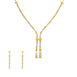 An image of a 22K gold jewelry set featuring a necklace and matching earrings crafted by Virani Jewelers