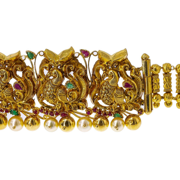 22K Yellow Gold Peacock Vaddanam Waist Belt W/ Emeralds, Rubies, Pearls & Detachable Centerpiece - Virani Jewelers | Add movement and luxury to your most festive looks with Vaddanam waist belts. This 22K yellow gol...