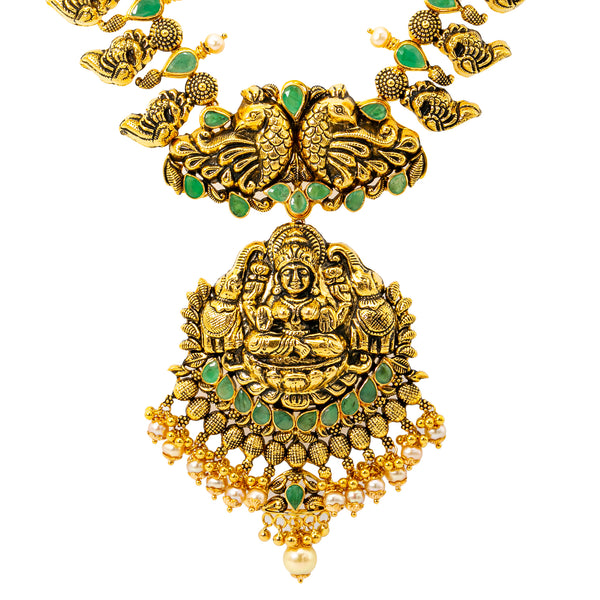 22K Antique Gold, Emerald, & Pearl Goddess Laxmi Necklace (90.3 grams) | 
The 22k antique gold Goddess Laxmi necklace has an array of shimmering green emeralds & pear...