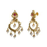 A close-up, side view of a pair of earrings in an Indian jewelry set from Virani Jewelers | Accessorize elegantly with this 22K yellow gold necklace and earring set from Virani Jewelers!

M...