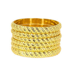 Set of six 22K yellow gold bangles with slanted gold accents and intricate details around each band.